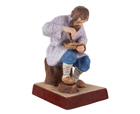 A RUSSIAN PORCELAIN FIGURE OF A BAST SHOE MAKER, GARDNER PORCELAIN FACTORY, MOSCOW, LATE 19TH CENTURY  realistically modeled,