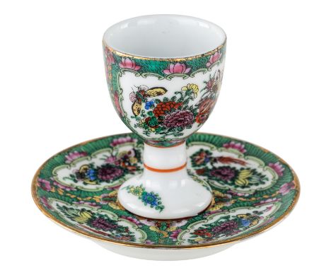A SMALL GILT PORCELAIN DRINKING CUP AND SAUCER comprising:a) a drinking cup with floral cartouches and gilt rim on a circular