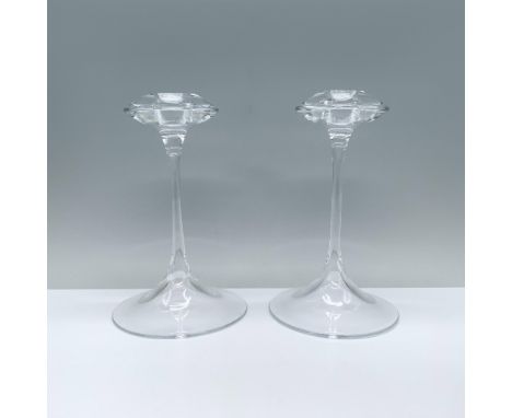 An elegant pair of clear candlesticks featuring a rounded base, a slender stem, and a cymbal-shaped top with a candle holder.