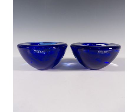 A set of 2 clear votive glass candle holders with navy-blue swirls. Kosta Boda stickered. Artist: Anna EhrnerDimensions: 4.5"