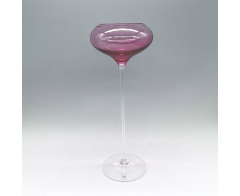 A clear long stem footed glass candleholder with a pink glass bowl on top. Orrefors marked. Artist: Erika LagerbielkeIssued: 