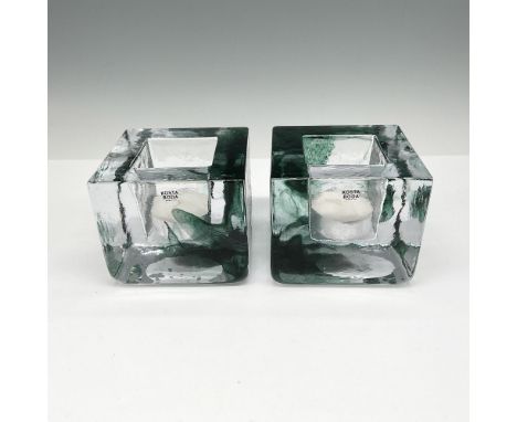 Mouth blown and hand formed cube design of clear crystal with green ribbon color. Kosta Boda mark. This item has its original