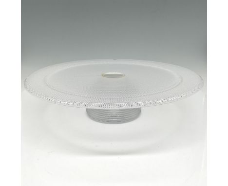 Textured clear glass on stacked footed base. Kosta Boda mark. This item has its original box: 13"L x 13"W x 4.5"H. Issued: 21