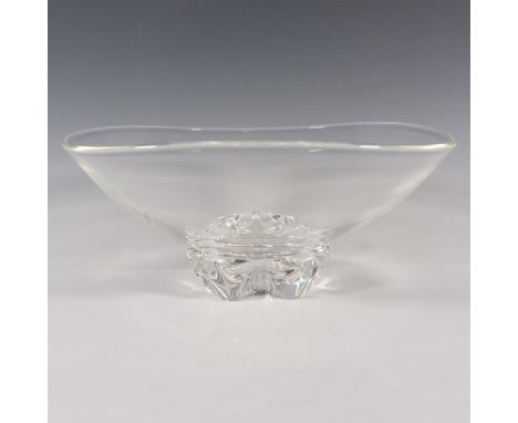 A clear footed bowl with three smooth indents on the base. Steuben etched signature on the underside. Artist: Donald PollardD