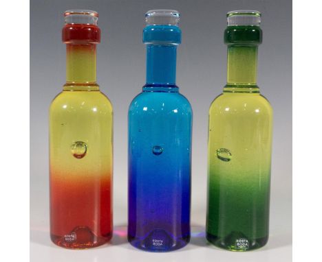 A set of 3 colored glass sculptures in a shape of a wine bottle. One blue, one green, and the third red. Each with a controll