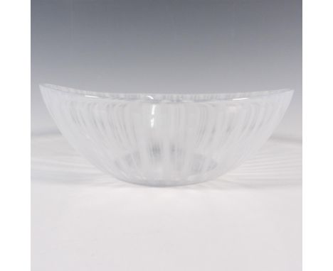 An oval form clear bowl with snowy-white vertical streaks. Orrefors stickered on the side, and engraved on the underside. Thi