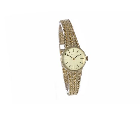 LADY'S ZENITH NINE CARAT GOLD MANUAL WIND WRIST WATCH1790s, the champagne coloured dial with applied gold coloured baton hour
