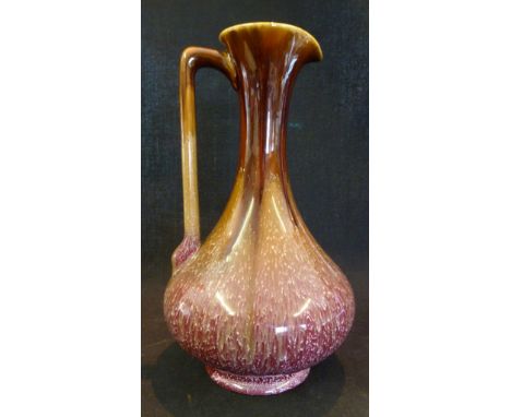 Linthorpe Pottery from a Design by Christopher Dresser, a shaped jug with mottled slip glazed decoration, 23 cms high