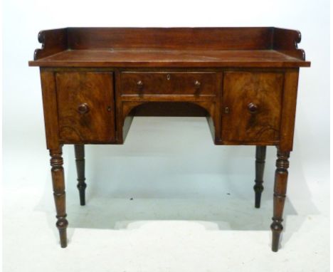 A Regency Mahogany Small Sideboard, with a galleried back above a central drawer flanked by cupboard doors, raised upon ring 