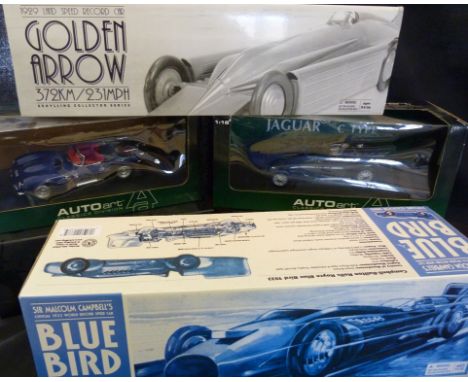 A Large Model of Sir Malcolm Campbell's Bluebird, within original box, together with another similar The Golden Arrow and fou