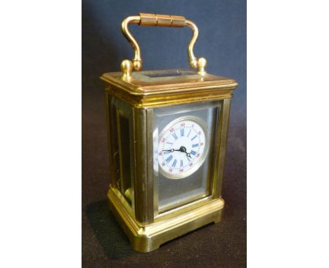 A Miniature French Brass Cased Carriage Clock, the enamel dial with Roman and Arabic numerals and with lever escapement 