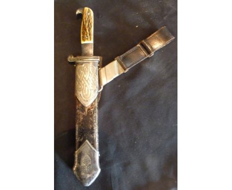 A World War II German Dagger, with bone grip and part leather scabbard, complete with leather hanger