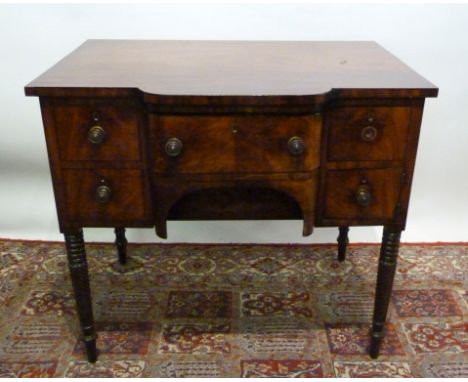 A William IV Mahogany Small Sideboard, with a central drawer flanked by cupboards and drawers with brass knob handles raised 