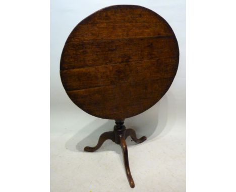 A George III Oak Pedestal Table, the circular top above a turned centre column raised upon tripartite legs with pad feet