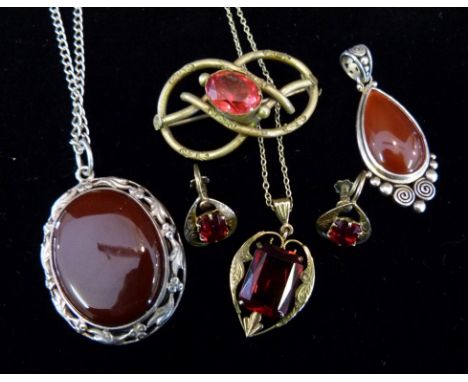 A Suite of Jewellery comprising a red stone set pendant with chain, together with a pair of matching earrings, two pendants a