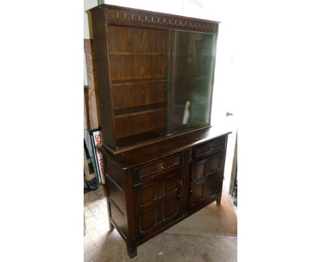 An Ercol Sideboard, together with a similar bookcase top and a set of four stick back chairs