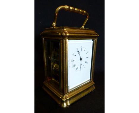 A 19th Century French Brass Cased Carriage Clock, the enamel dial with Roman and Arabic numerals and with lever escapement an