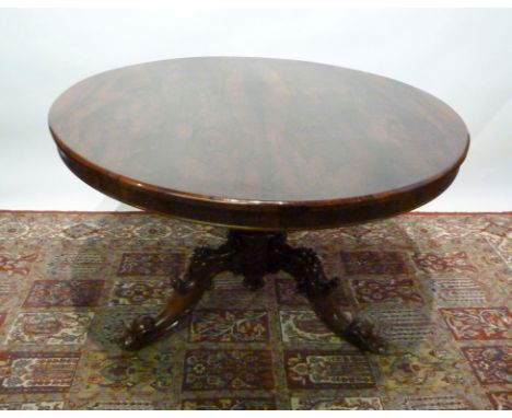 A William IV Rosewood Centre Table, the circular top above a carved centre column and tripartite base with scroll feet, 121 c