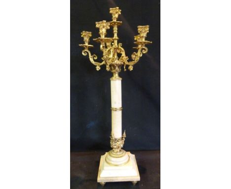 A French Ormolu and Marble Candelabrum, with six shaped arms above a turned centre column and stepped square base, 65cms high