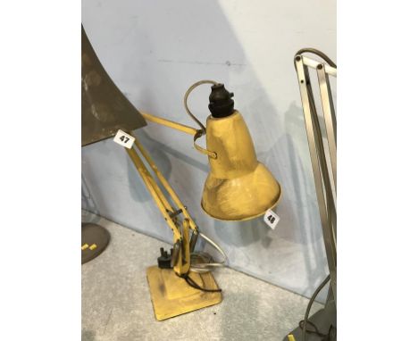 A yellow Herbert Terry and Sons angle poise lamp