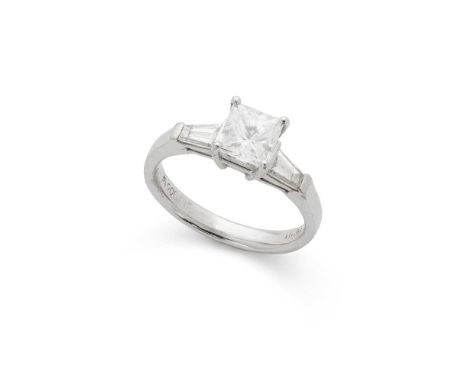 A diamond single-stone ring claw-set with a princess-cut diamond, between tapered baguette-cut diamond shoulders, stamped Pt9