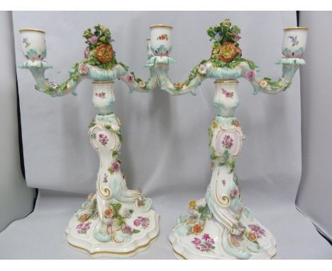 A pair of Meissen porcelain candelabra, each two light with central bouquet finial on rococco stem and base and encrusted wit