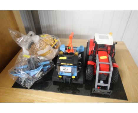 A Playmobil snow groomer and a Playmobil tractor. With various attachments etc.