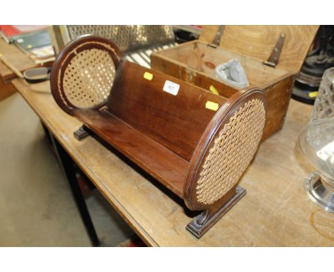 A mahogany and wicker book trough