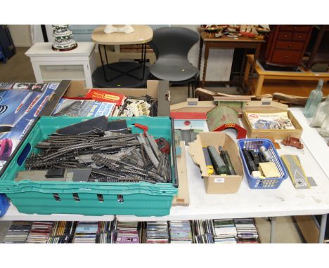A collection of model trains, accessories and two boxes of track