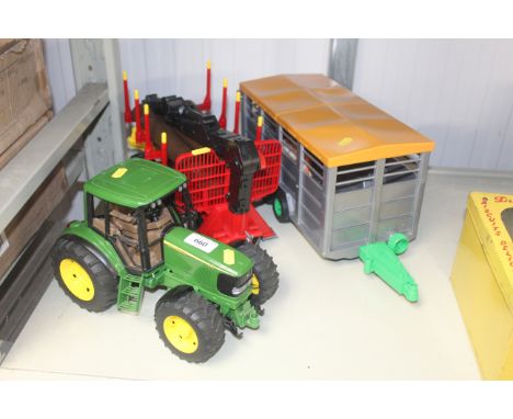 A Bruder 1/16th John Deere 6920 tractor with Bruder log trailer, logs and Bruder cattle trailer