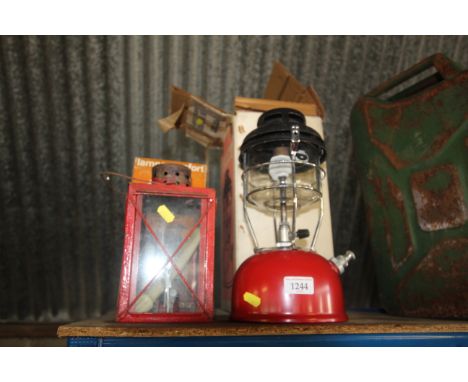 A Tilley X246B storm light with original box, as new; a  Confort lamp with original box and a hanging candle lantern