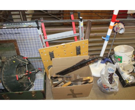 A metal folding workmate and a box containing various tools to include saws, wooden clamps etc.