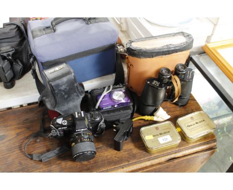 A Minolta X300 camera, a pair of 16 x 50 binoculars, a digital camera etc.