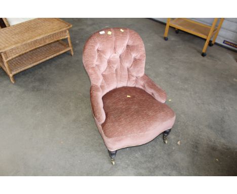A Victorian button back upholstered armchair