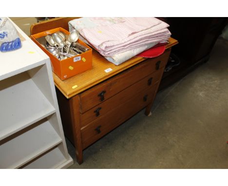A light oak chest fitted three drawers