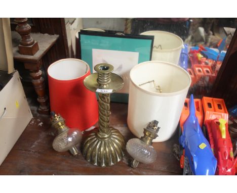 A brass candlestick; two brass and glass oil lamps and watercolour study of a duck