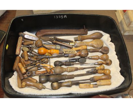 A quantity of various wooden handled hand tools including rotary borers. screwdrivers etc