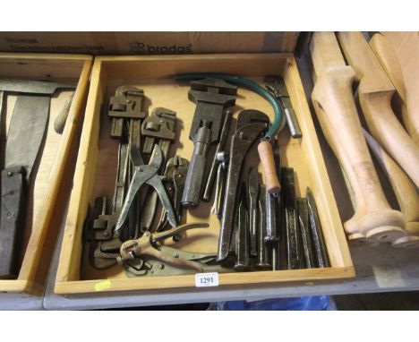 A quantity of various tools including adjustable pipe wrenches, mole grips and metal chisels 