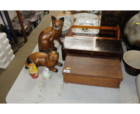 A pine book trough and two wooden boxes, two wooden cat ornaments, a Russian doll and a trinket box