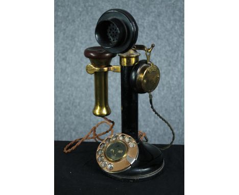 An old candlestick phone made of brass and bakelite. H.31 cm. 