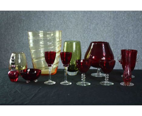 Studio glass. A mixed collection of coloured glass including vases and a pair of ruby glass sherry and wine glasses. H.23 Dia