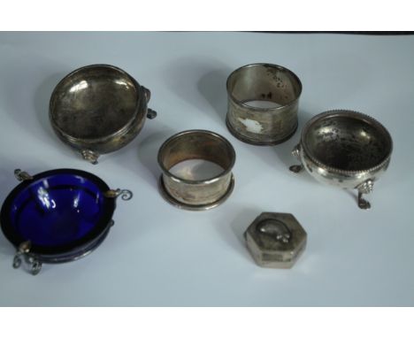 A collection of silver and white metal, including two silver salts, two silver napkin rings, a white metal trinket box and a 