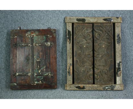 An Eastern teak window pane mirror with shutters and a similar missing it's glass. H.74 W.57cm. (largest) 