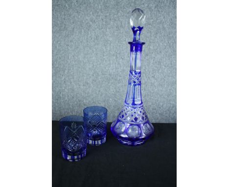 A blue glass decanter and a pair of matching glasses. H.36 cm. (largest) 