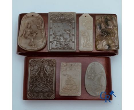 Asian art: 7 Chinese jade amulets. 19th-20th century and 2 wooden plinths. largest amulet: 7.5 x 5.5 cm.