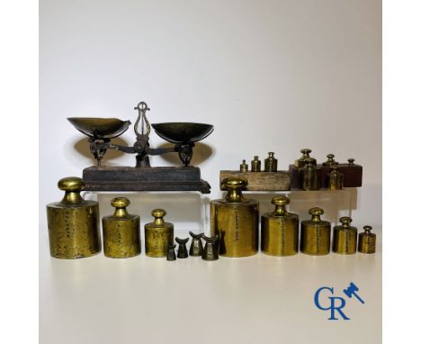 A various lot of antique calibration weights and a calibrated scale. 18th-19th century. Heaviest weights: 5 kg.
