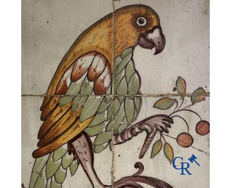 A polychrome tile panel in faience with a parrot. Probably northern France. (Lille) 18th century. 38 x 25,5 cm.