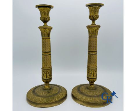 Pair of Charles X candlesticks in gilded bronze. Height: 30.5 cm.Base diameter: 14 cm.