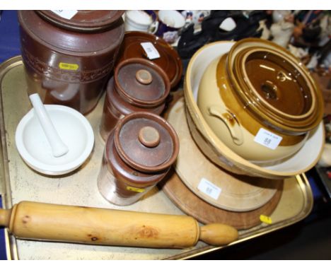 Three 19th century stoneware storage jars, two stoneware casseroles and covers, a boxwood rolling pin, two turned wood breadb