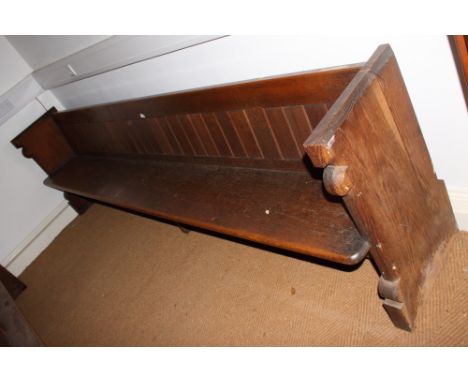 A carved oak pew with trefoil panel ends, 120" long